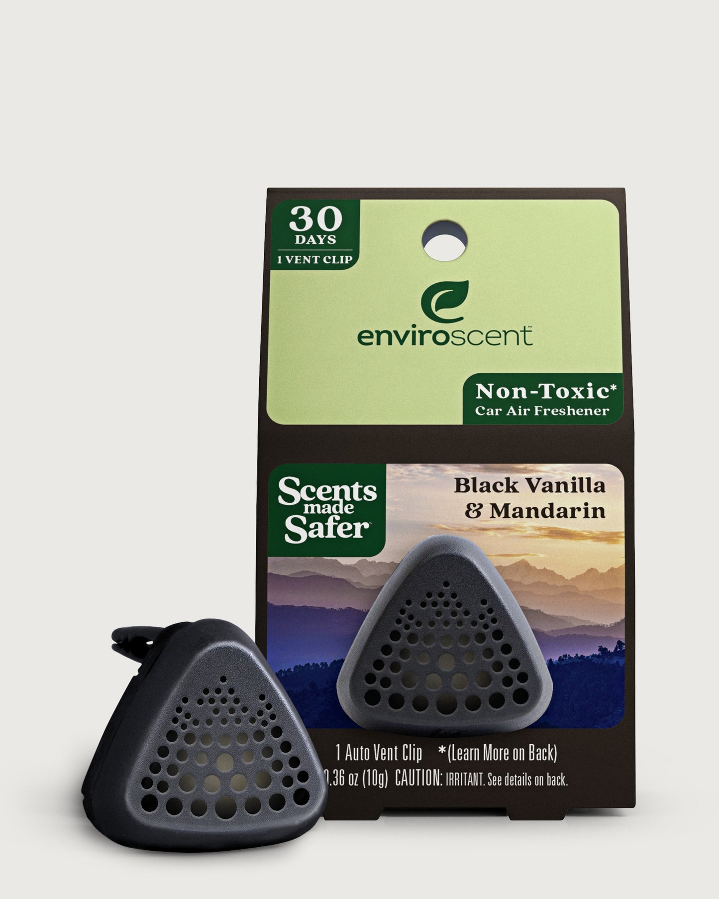 Enviroscent car air freshener vent clip in front of their retail packaging, Black Vanilla & Mandarin scent.